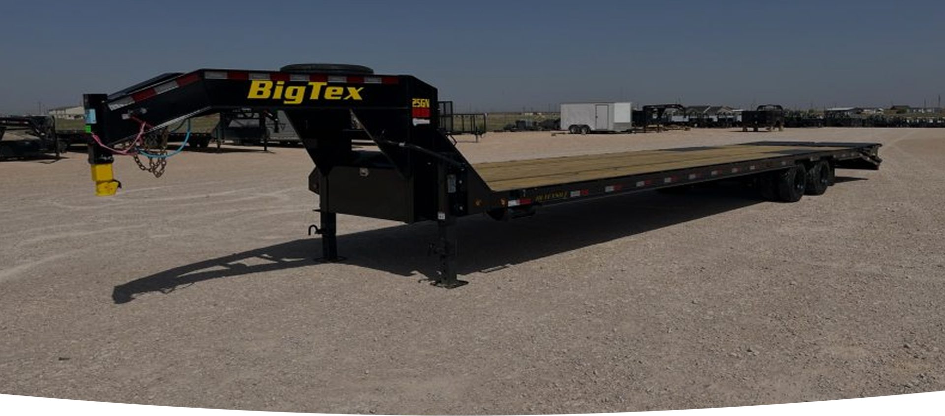 A big tex trailer with a flatbed attached.